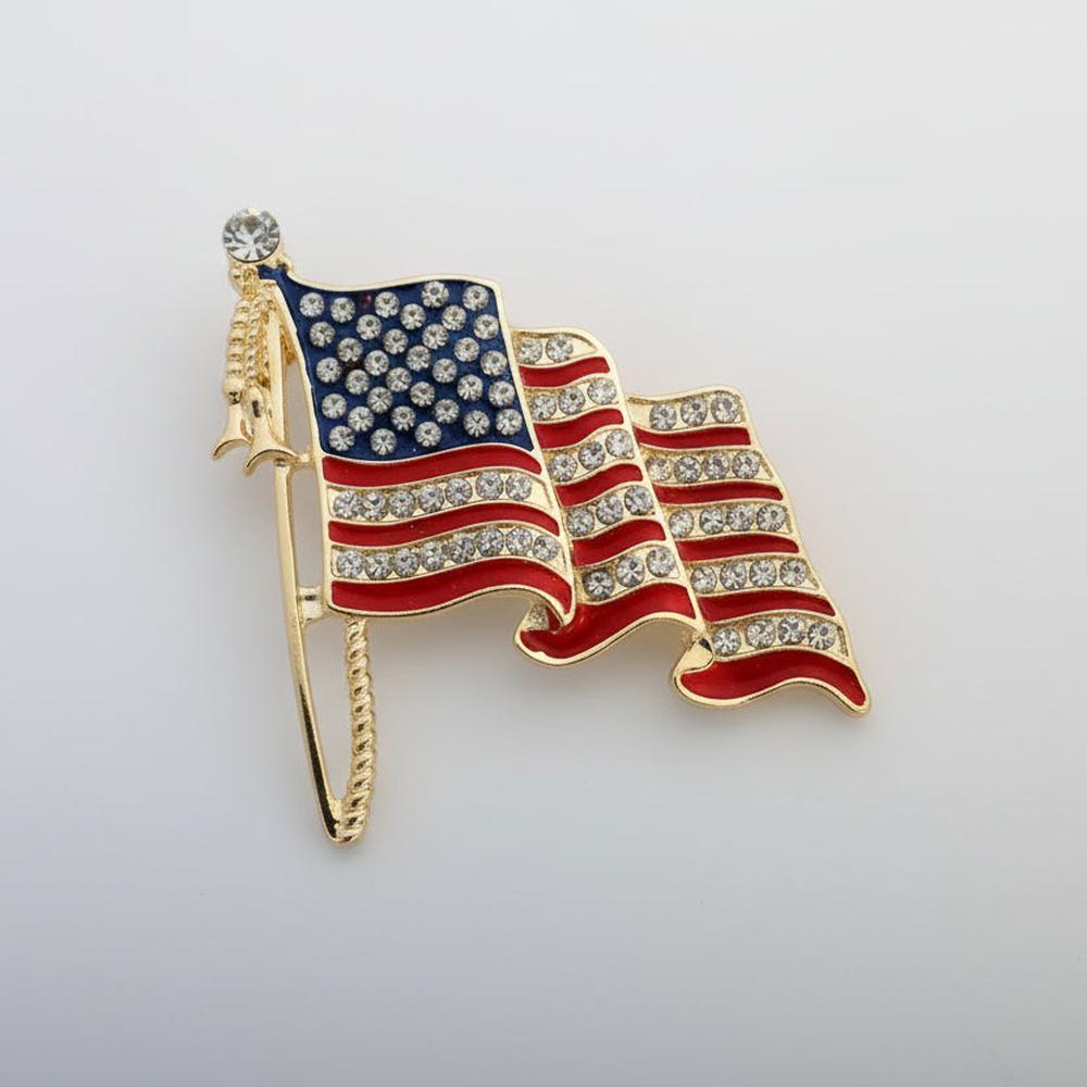 American flag brooch accented with rhinestones on a light gray background