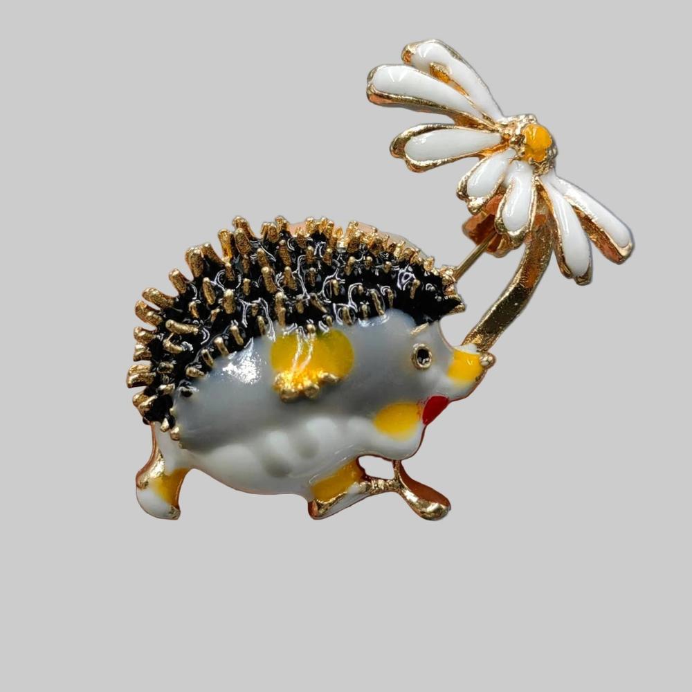 Hedgehog design brooch on a light gray background