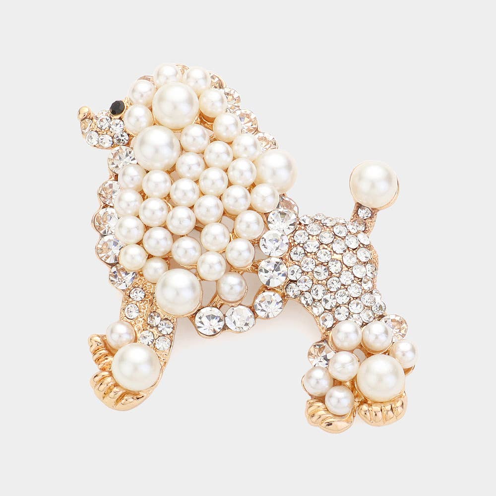 Ivory pearl and rhinestone poodle shaped brooch on a light gray background