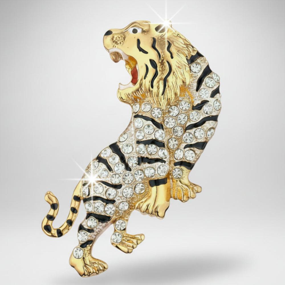Gold and black rhinestone tiger brooch on a light gray background