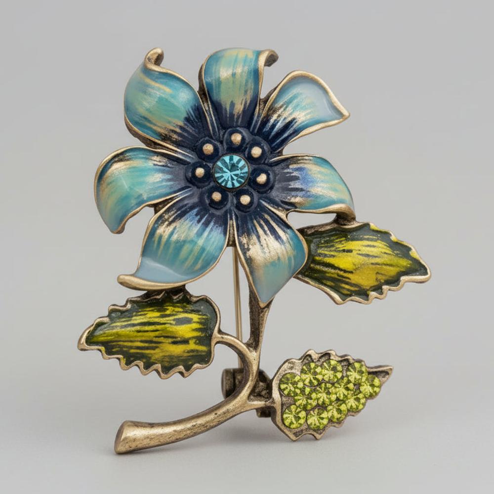 Floral brooch with blue and green colors on a light gray background