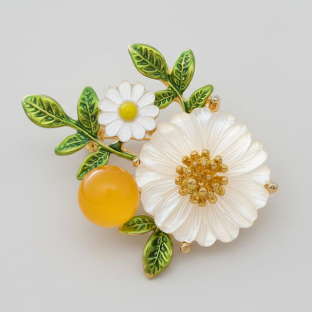 Floral brooch with white flowers, green leaves, and a yellow berry on a light gray background
